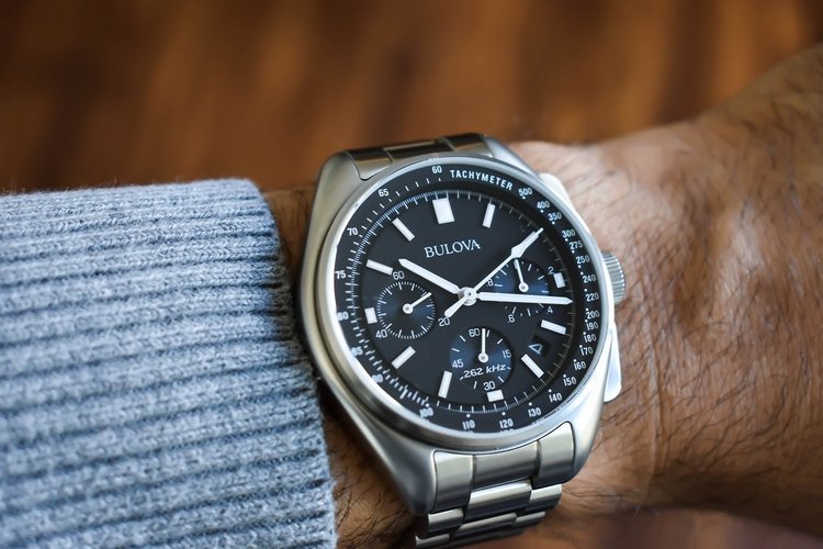 Bulova Lunar Pilot chronograph with black dial and three subdials on steel bracelet, worn on the wrist