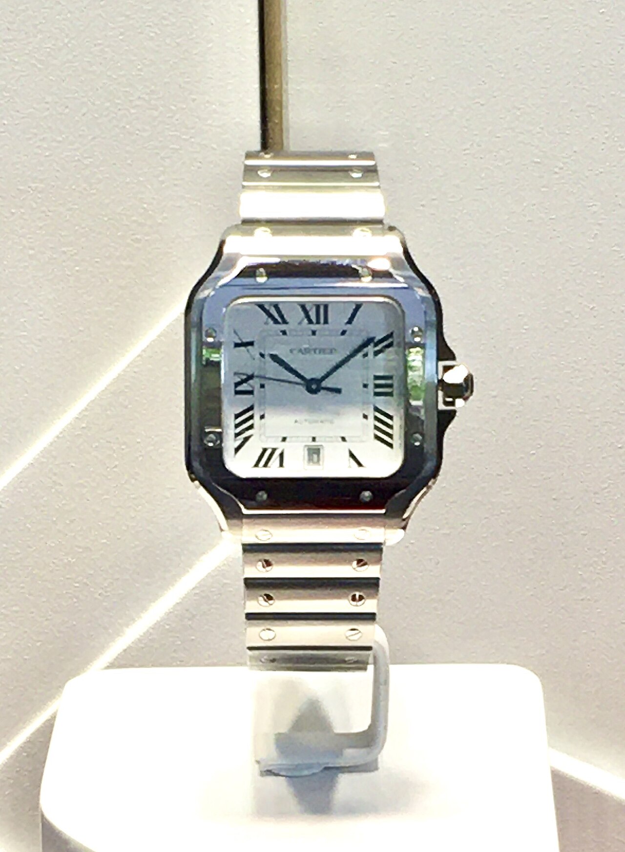 Cartier Santos wristwatch with square bezel and exposed screws on steel bracelet