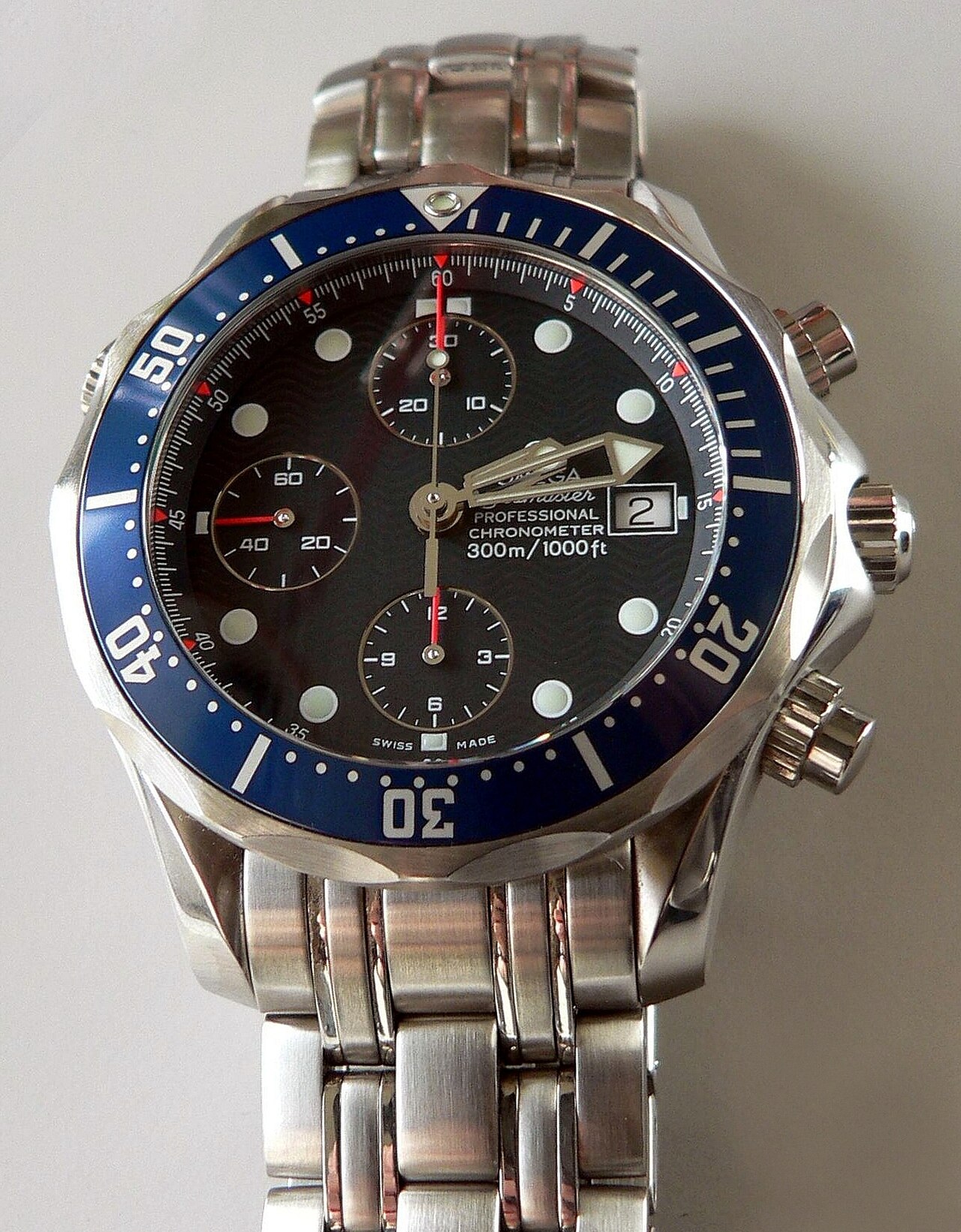 Omega Seamaster 300M with wave-pattern dial and scalloped dive bezel on steel bracelet (previous-generation chronograph shown)
